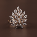Top down and profile view of a 2 carat marquise cut lab grown diamond statement ring in 14k yellow gold featuring a sunburst cluster design with tiered architecture and white gold prongs for maximum icy brilliance on a hand.