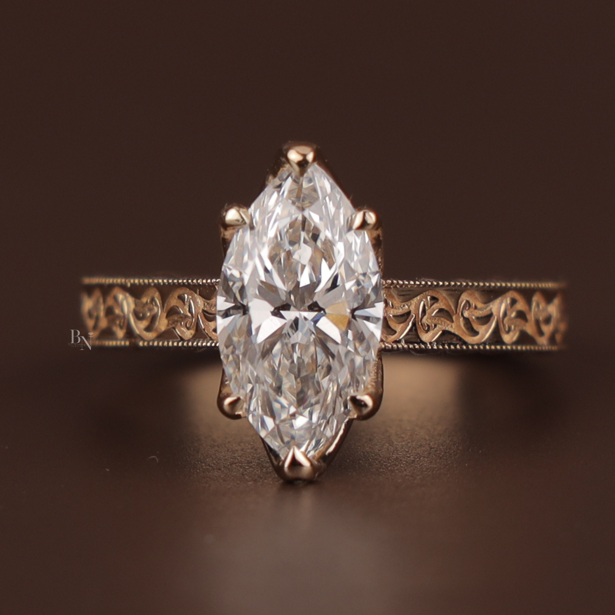 2 carat marquise cut lab grown diamond set in a 14k rose gold vintage cathedral setting with intricate filigree engraving, milgrain details, and a sparkling hidden halo under the center stone.
