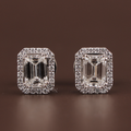 3 carat total weight emerald cut lab grown diamond stud earrings in 14k white gold with a convertible pave halo jacket showing secure screw back posts and crisp step-cut facets on a dark background.