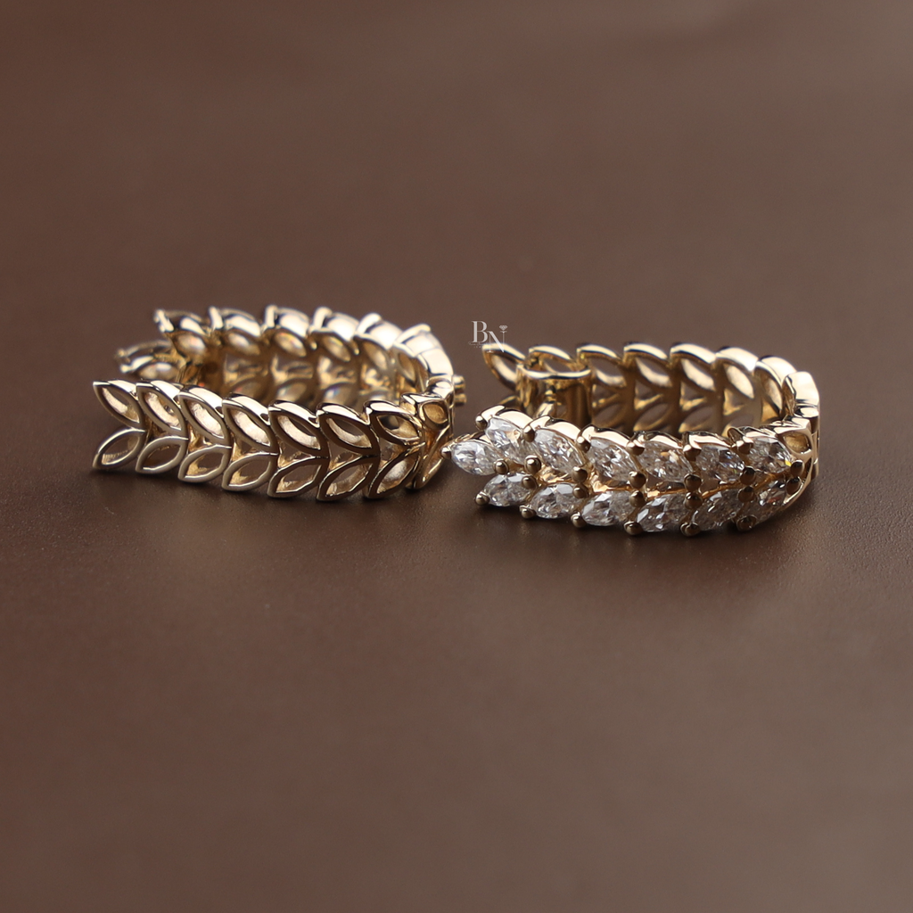 Detailed view of 0.70 carat lab grown marquise diamond huggie hoop earrings in 14k yellow gold featuring a nature-inspired double-row leaf vine pattern with sparkling brilliant white diamonds for a luxury bridal or anniversary jewelry gift.
