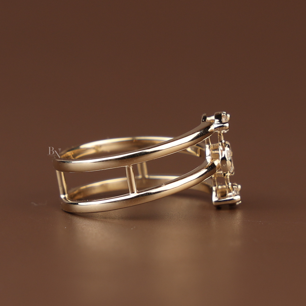Front view of a triple row bypass ring in 14k yellow gold featuring three parallel bands connected by a vertical cluster of lab grown diamonds including two marquise and one center round brilliant stone in a modern minimalist cage setting.