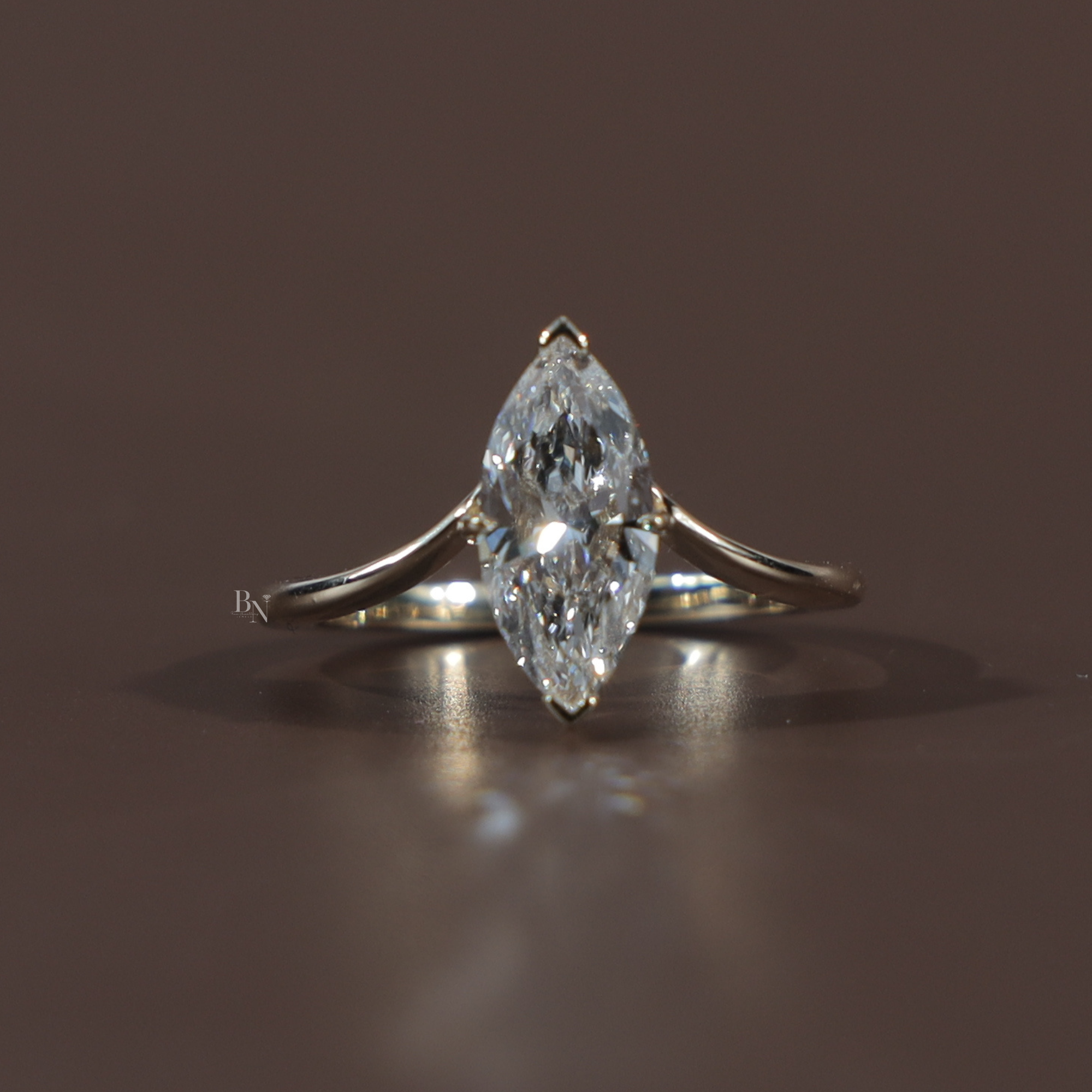 1.50 carat marquise cut lab grown diamond engagement ring in 14k white gold featuring a hidden halo under-setting and a polished tapered cathedral band shown on a hand and black silk background for luxury scale and detail.