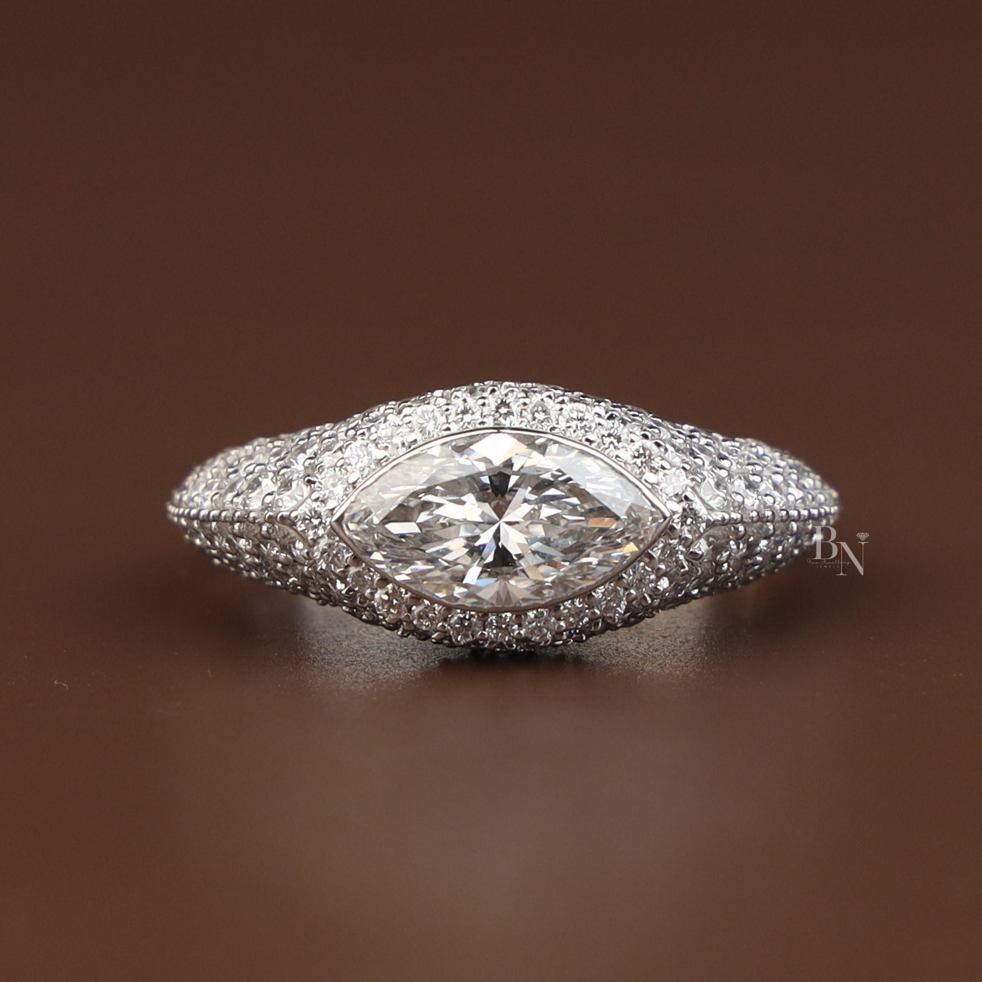2 carat marquise cut lab grown diamond engagement ring in 14k white gold featuring a shimmering hidden halo and tapered pave diamond band with a high profile cathedral setting and pave bridge detail.