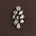 Macro view of 2.50 carat lab grown diamond mixed cut cluster pendant in 14k yellow gold featuring round brilliant, pear, emerald, and marquise diamonds on a gold chain for a high-end luxury bridal or anniversary jewelry gift.