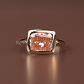 Three carat fancy pink cushion cut lab grown diamond engagement ring in solid rose gold featuring a horizontal east-west bezel setting on a sleek split-shoulder cathedral band shown from top, side, and hand-worn angles.