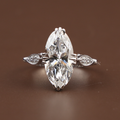 3 carat moval cut lab grown diamond engagement ring in 14k white gold with six-prong V-tip setting and vintage split-shank band featuring pavé navette shoulders and milgrain edges.