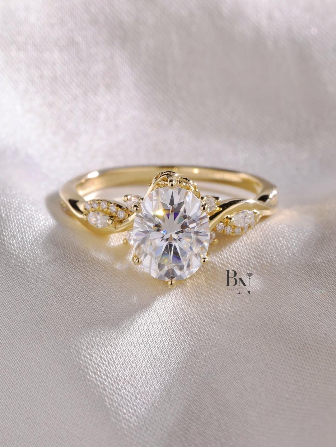 A 1 carat oval lab diamond engagement ring with a nature-inspired twisted vine band and leaf-shaped diamond accents in 14k yellow gold.
