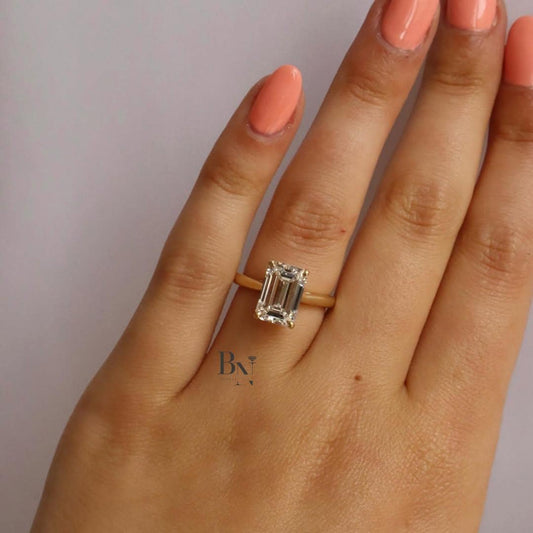 IGI certified 3.75 carat emerald cut lab grown diamond engagement ring with a hidden halo on a thin yellow gold band.