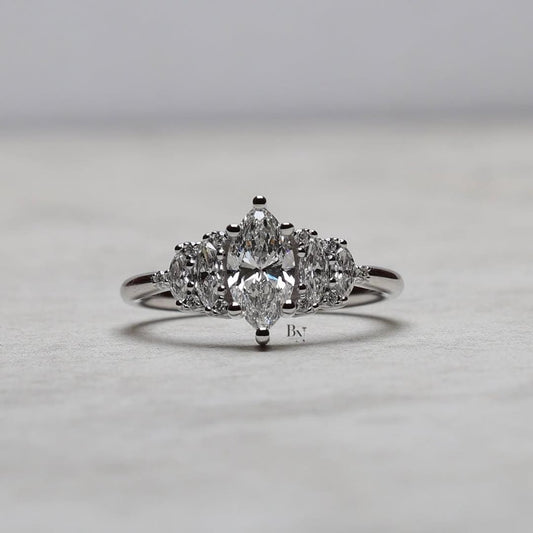 Close-up of a 1 CTW marquise and round lab diamond cluster ring in a jewelry box. The intricate five-stone design sparkles brilliantly in 14K white gold, highlighting its vintage, Art Deco-inspired craftsmanship and detail.