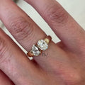 Luxurious 1.50 carat Toi et Moi lab grown diamond ring with oval and pear stones on a wide, thick cigar band in polished 14k yellow gold.