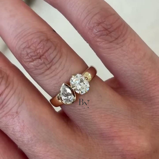 Luxurious 1.50 carat Toi et Moi lab grown diamond ring with oval and pear stones on a wide, thick cigar band in polished 14k yellow gold.