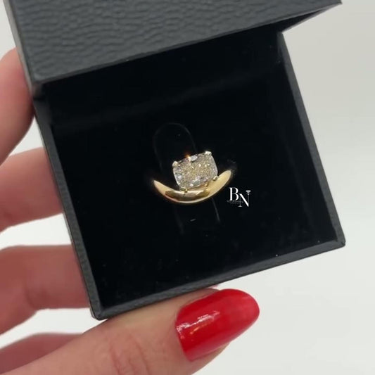 1.00 carat cushion cut lab diamond set in a sculptural yellow gold bypass engagement ring, featuring a semi-bezel setting for a sleek, modern, and low-profile look.