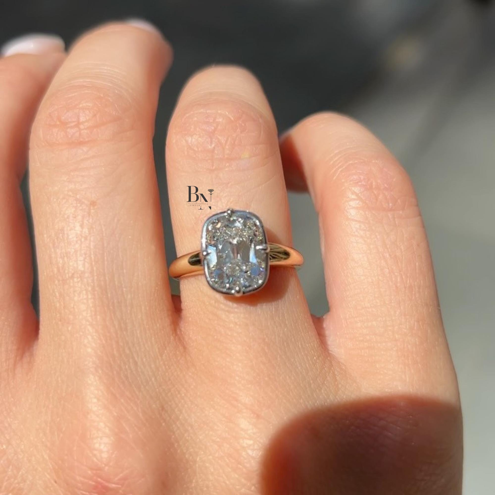 3.00 carat Old Mine Cushion cut lab diamond set in a sculptural two-tone bypass ring, featuring a semi-bezel setting on a wide yellow gold band.