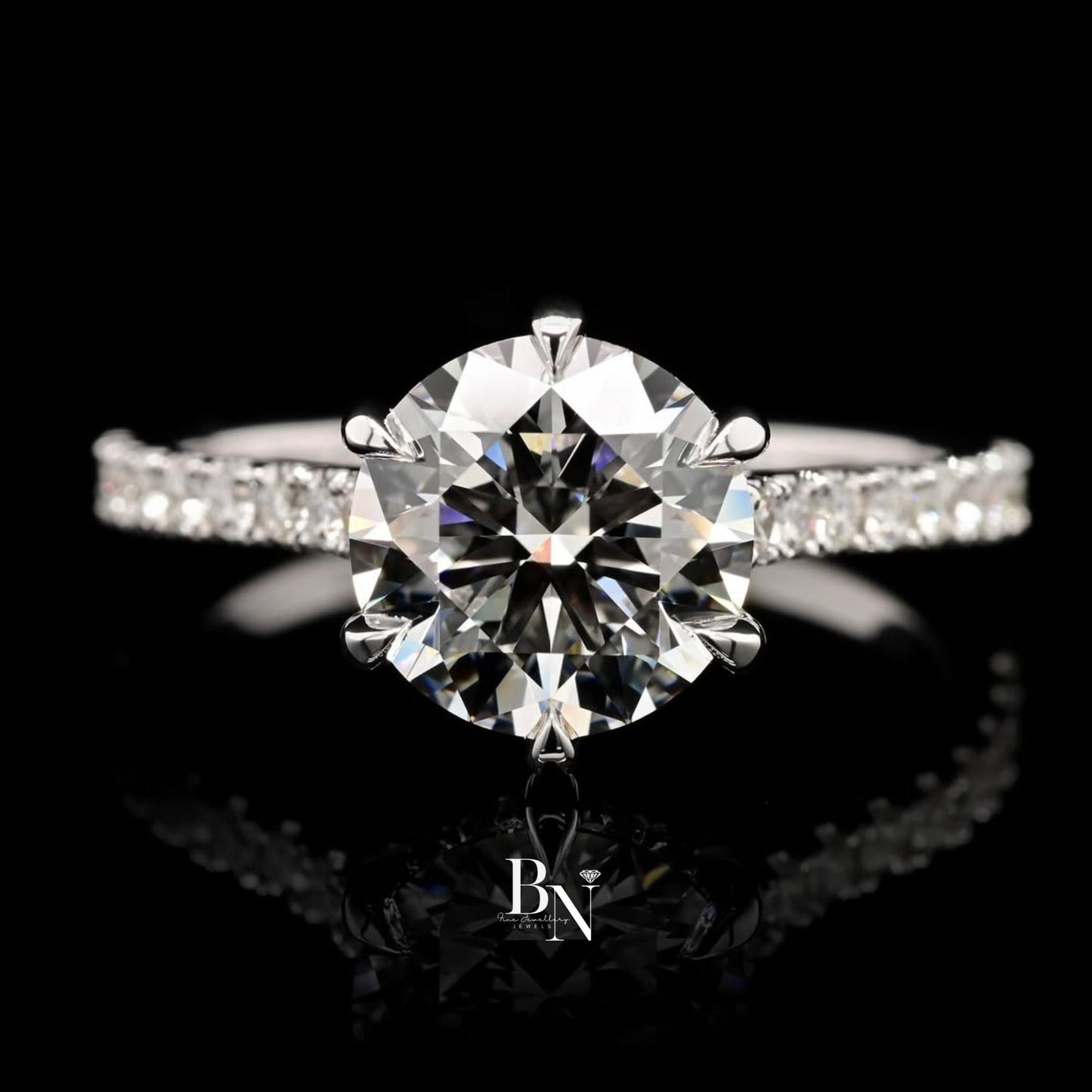 Elegant 1.00ct round brilliant lab grown diamond engagement ring in 14k yellow gold. Features a unique swirl bypass setting with a micro pave accent shank.