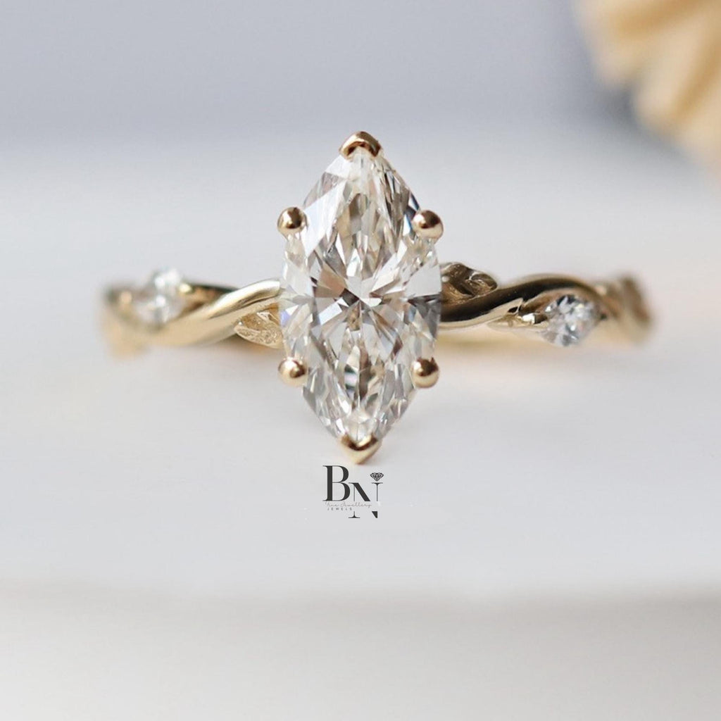 Close-up of 1.00 carat Marquise cut lab grown diamond set in a bespoke 14K Yellow Gold Twisted Vine setting with small accent side stones, highlighting the timeless, vintage design.