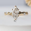 Close-up of 1.00 carat Marquise cut lab grown diamond set in a bespoke 14K Yellow Gold Twisted Vine setting with small accent side stones, highlighting the timeless, vintage design.