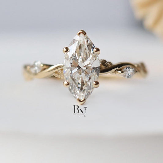 Close-up of 1.00 carat Marquise cut lab grown diamond set in a bespoke 14K Yellow Gold Twisted Vine setting with small accent side stones, highlighting the timeless, vintage design.