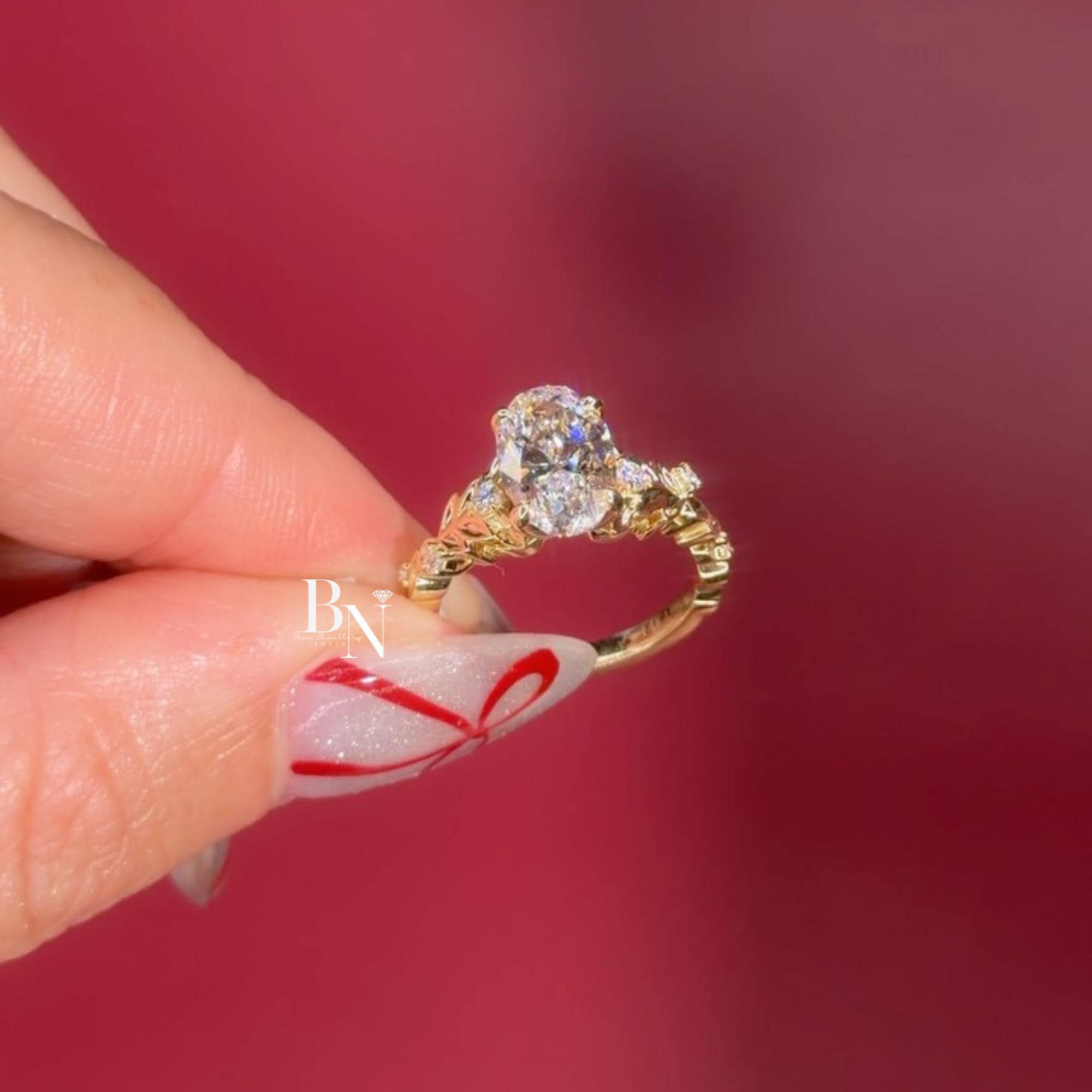 Exquisite 3.00ct elongated oval lab grown diamond engagement ring in 14k yellow gold. Features a romantic, nature-inspired vine floral accent band with marquise and round pave diamonds on the shoulders. A unique statement solitaire.