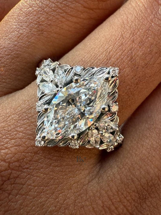 Close-up of 1.50 carat Marquise cut lab grown diamond set in a unique White Gold Nature-Inspired setting, framed by delicate leaf-shaped diamond accents and filigree work.