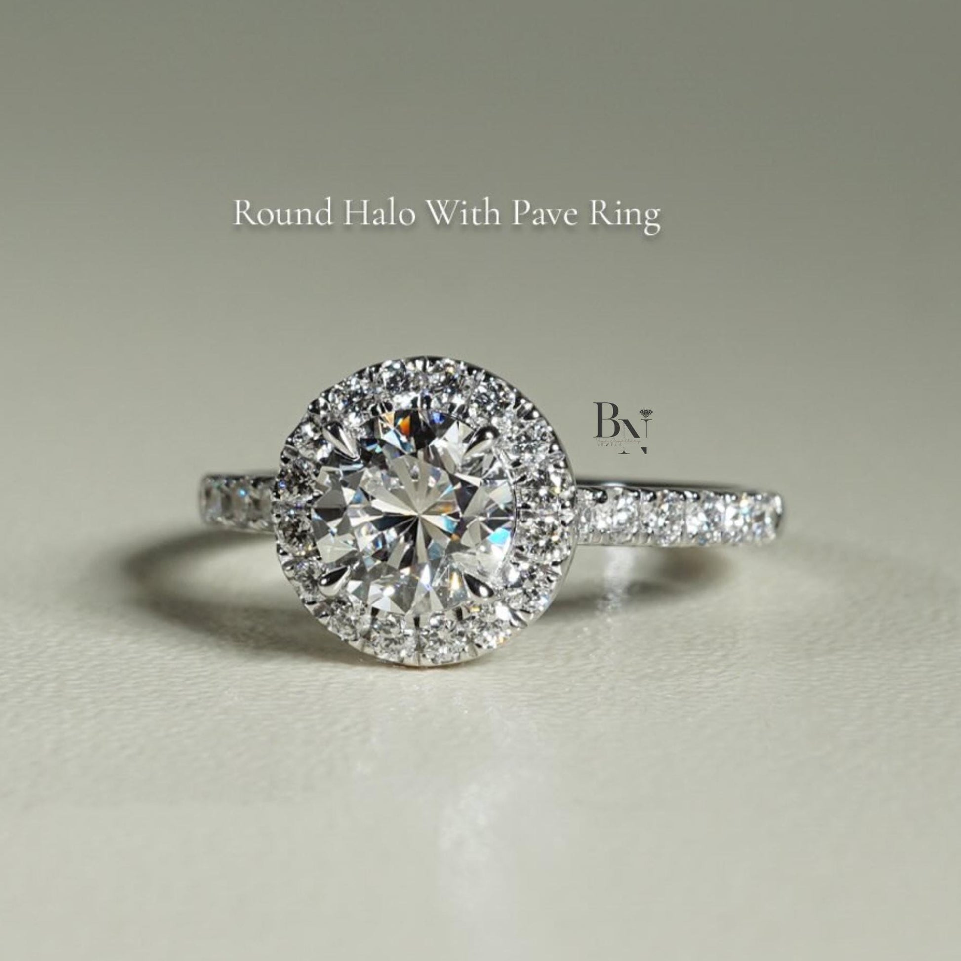 Close-up of 1 carat round brilliant cut lab grown diamond halo engagement ring in 14k white gold. Halo setting and pave band maximize stone size and crisp white light scintillation for Google Images.