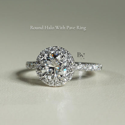 Close-up of 1 carat round brilliant cut lab grown diamond halo engagement ring in 14k white gold. Halo setting and pave band maximize stone size and crisp white light scintillation for Google Images.