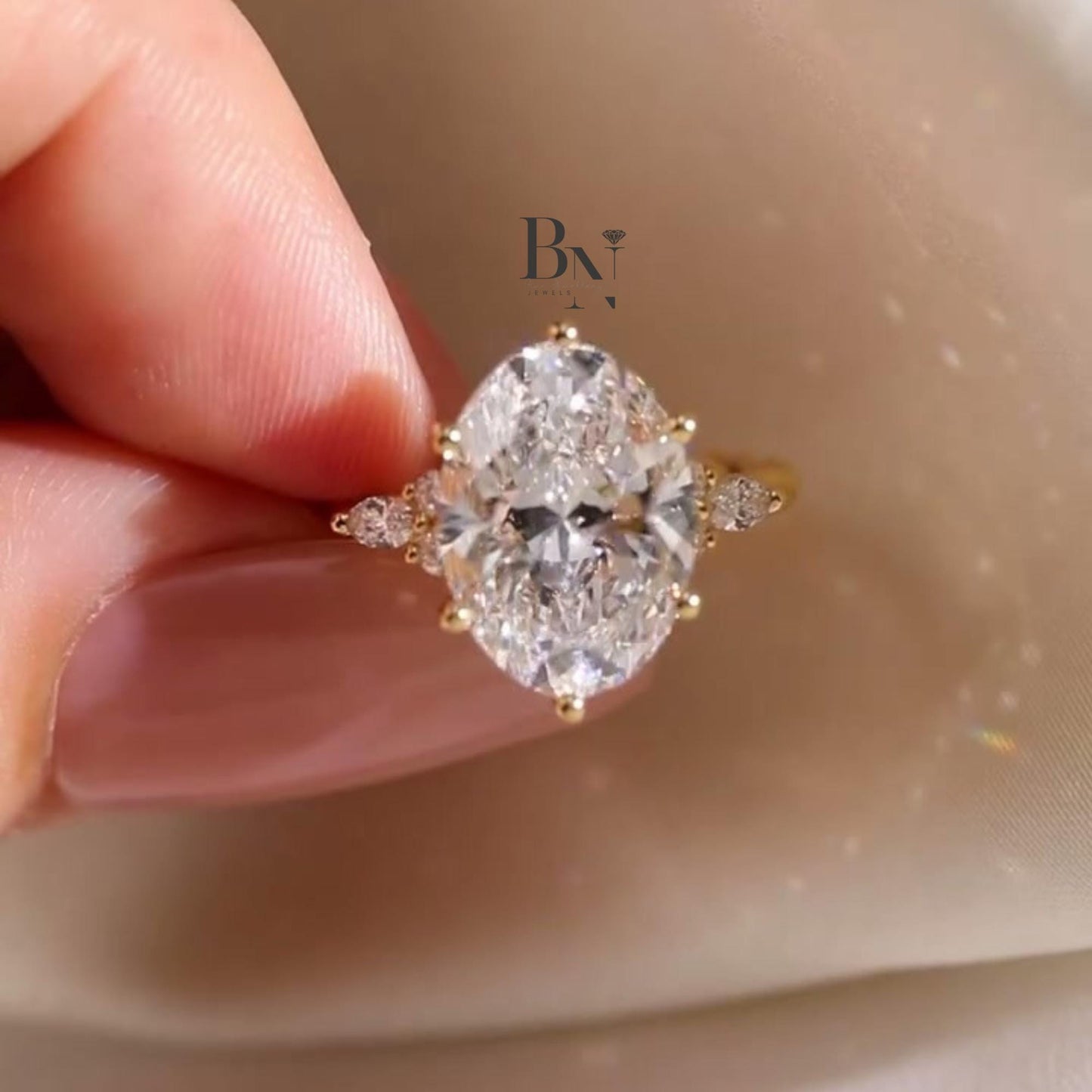 Artistic 3.00ct elongated oval lab grown diamond engagement ring in 14k yellow gold. Features a vine and floral inspired accent band with marquise and round pave diamonds.