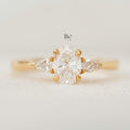 Elegant 1.00ct elongated oval lab grown diamond engagement ring in 14k yellow gold. Features romantic marquise and round dot accent diamonds on the dainty band.